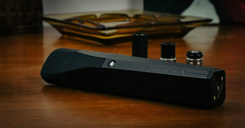 Black vaporizer on wooden table
